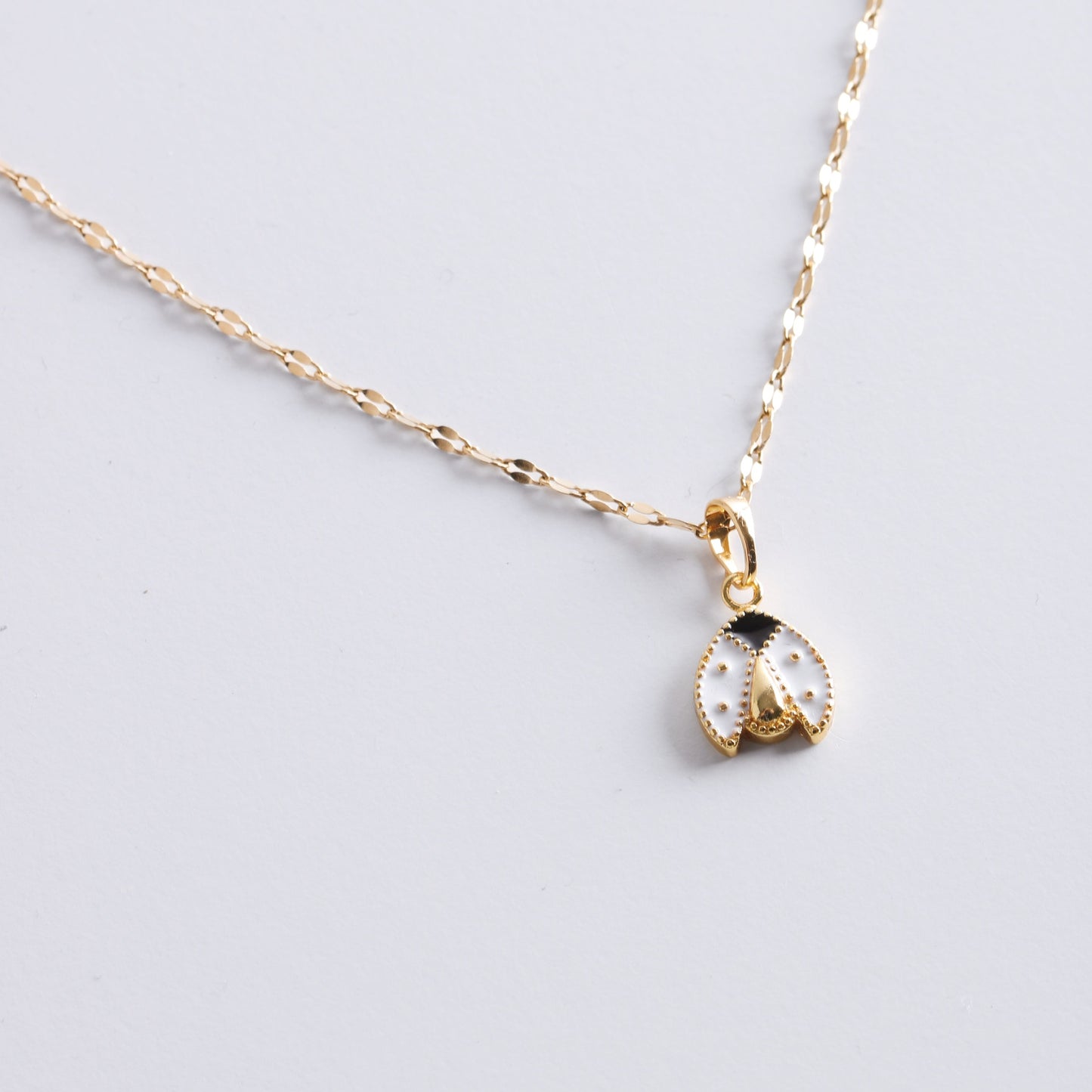 White Lady Bug Necklace In Gold